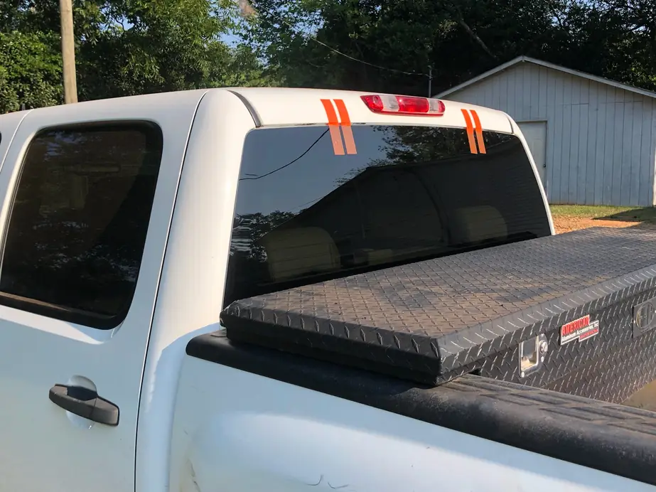 Pickup truck rear slider glass held in place with orange retention tape